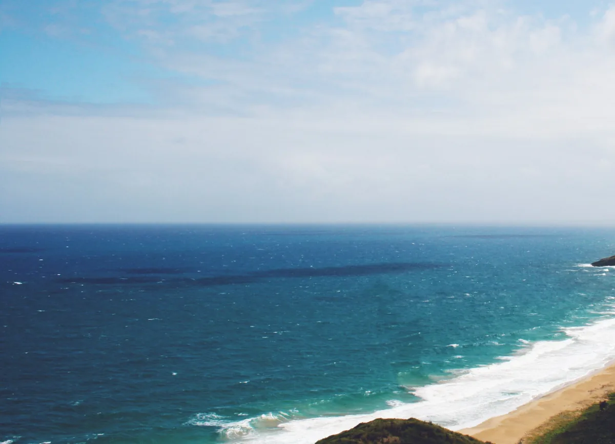 Waves rolling onto a sandy beach on St Kitts